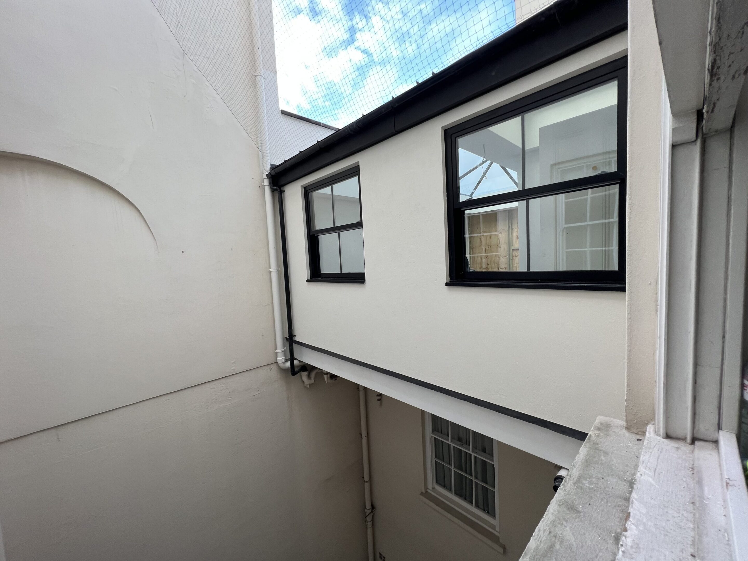 Narrow building courtyard with windows