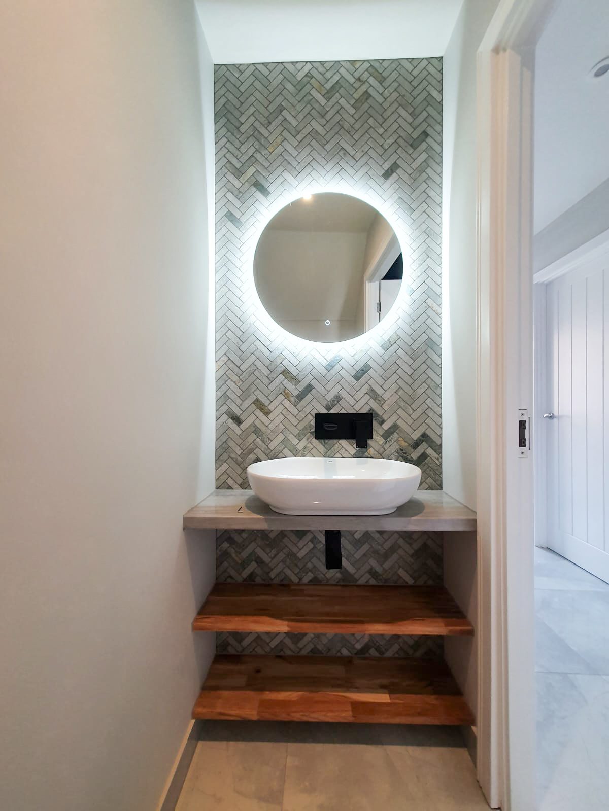 Illuminated mirror above bathroom sink