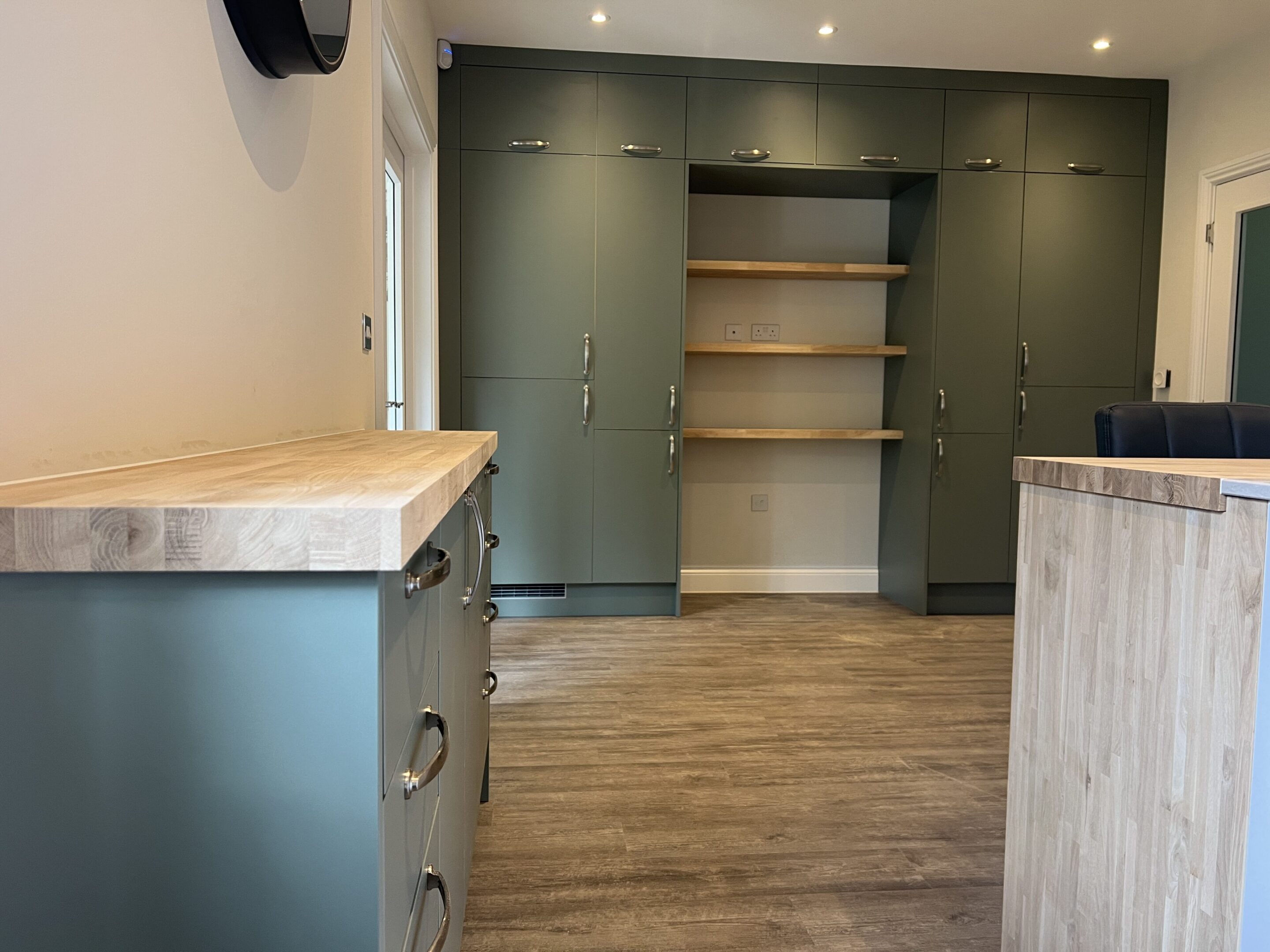 Modern kitchen with green cabinets and island