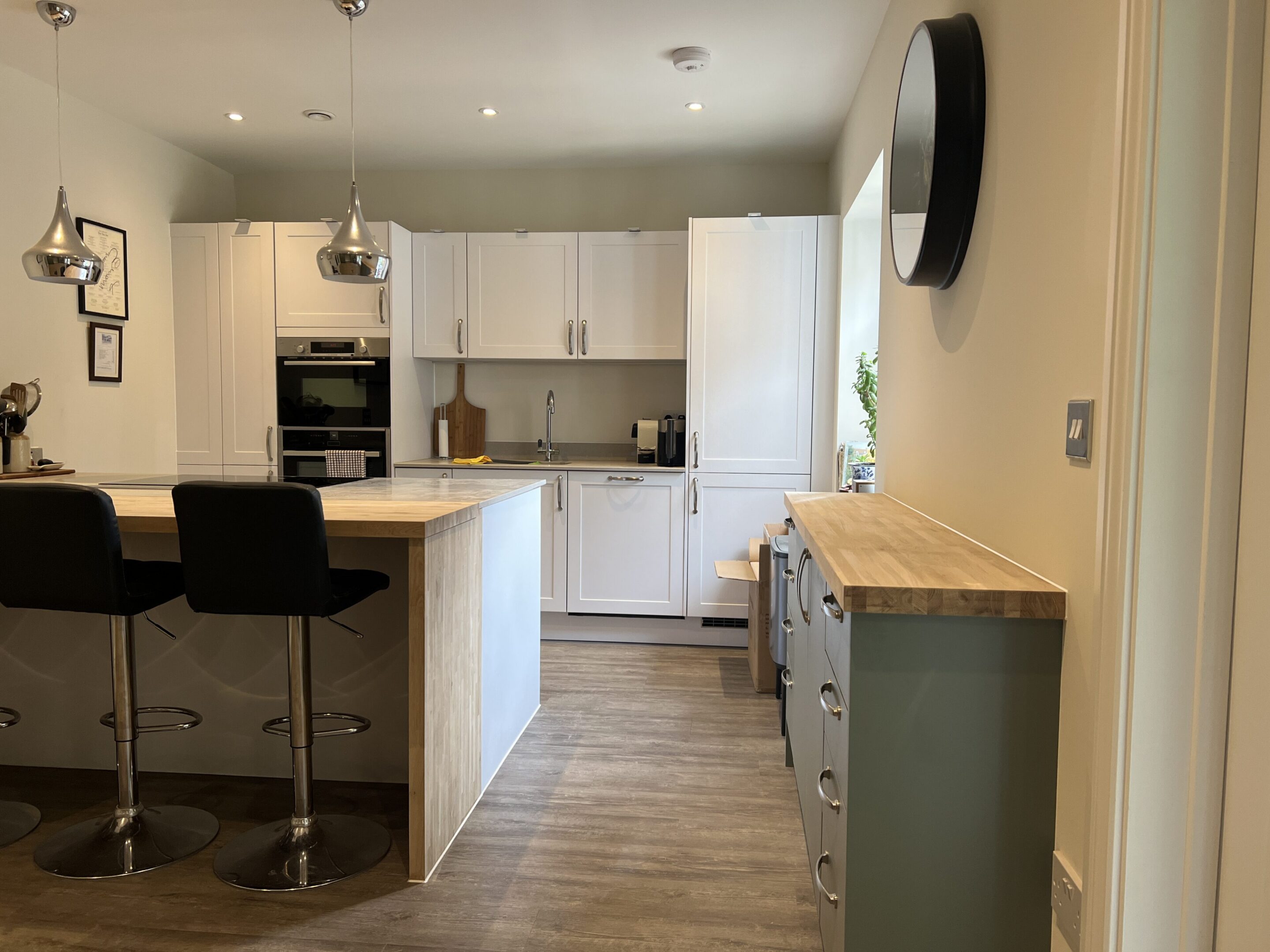 Modern white kitchen with island and stools