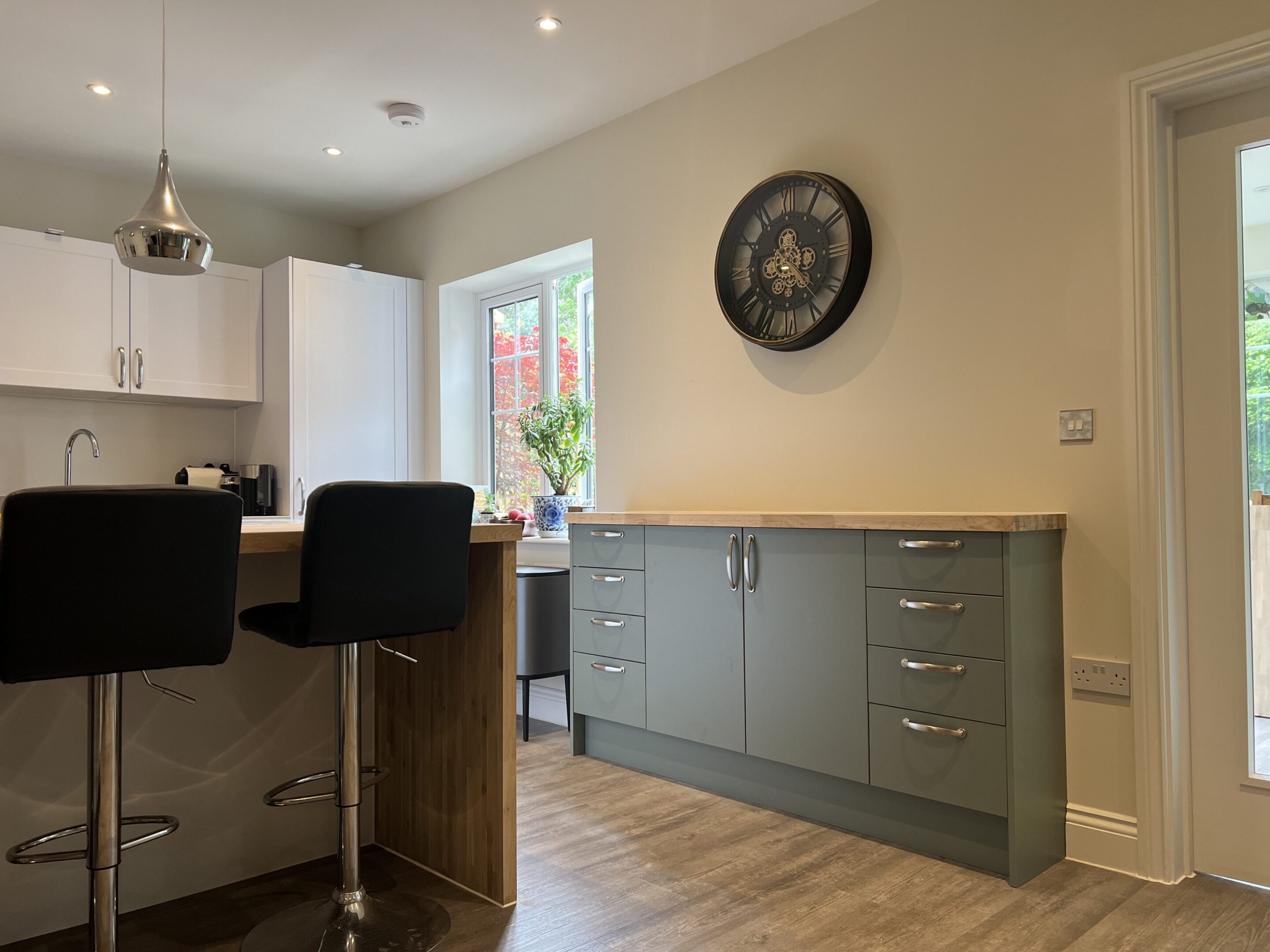 Modern kitchen with gray cabinets and barstools