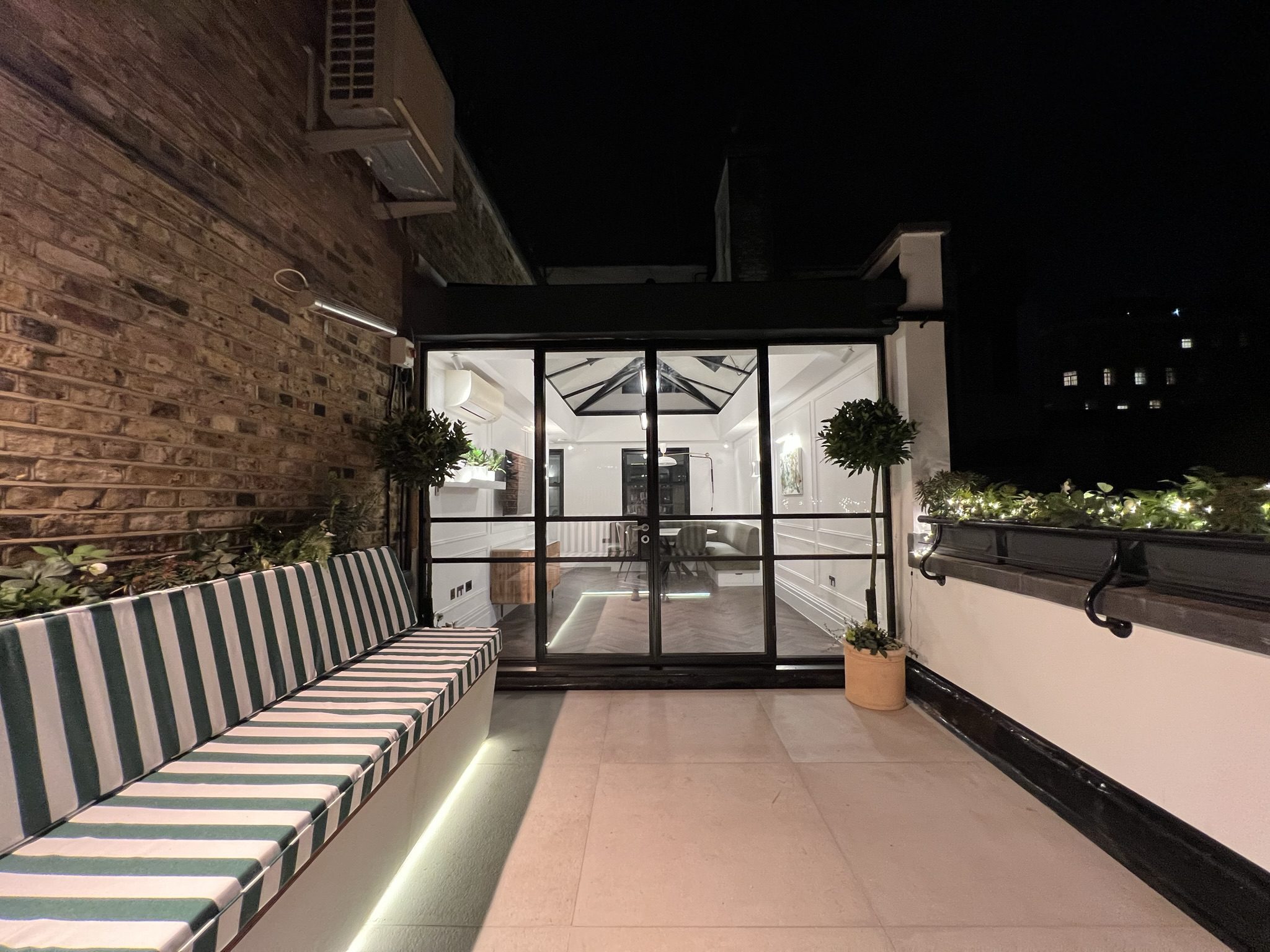 Modern rooftop terrace with striped bench seating