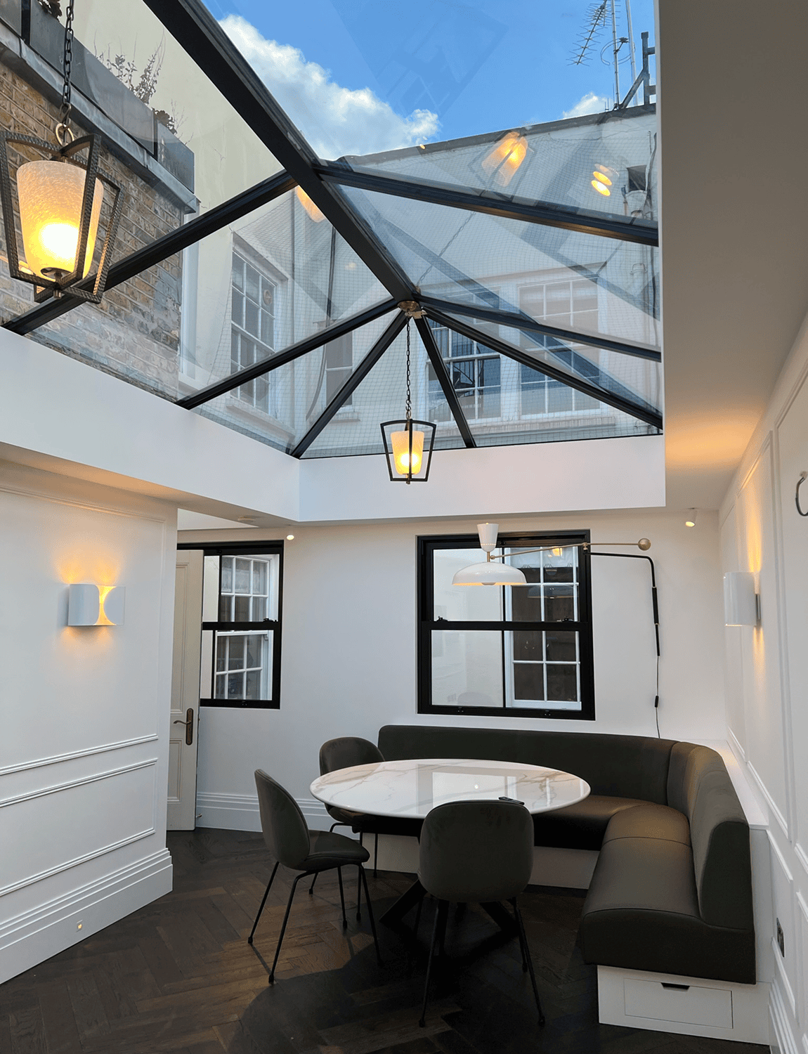 Skylit dining nook with corner banquette