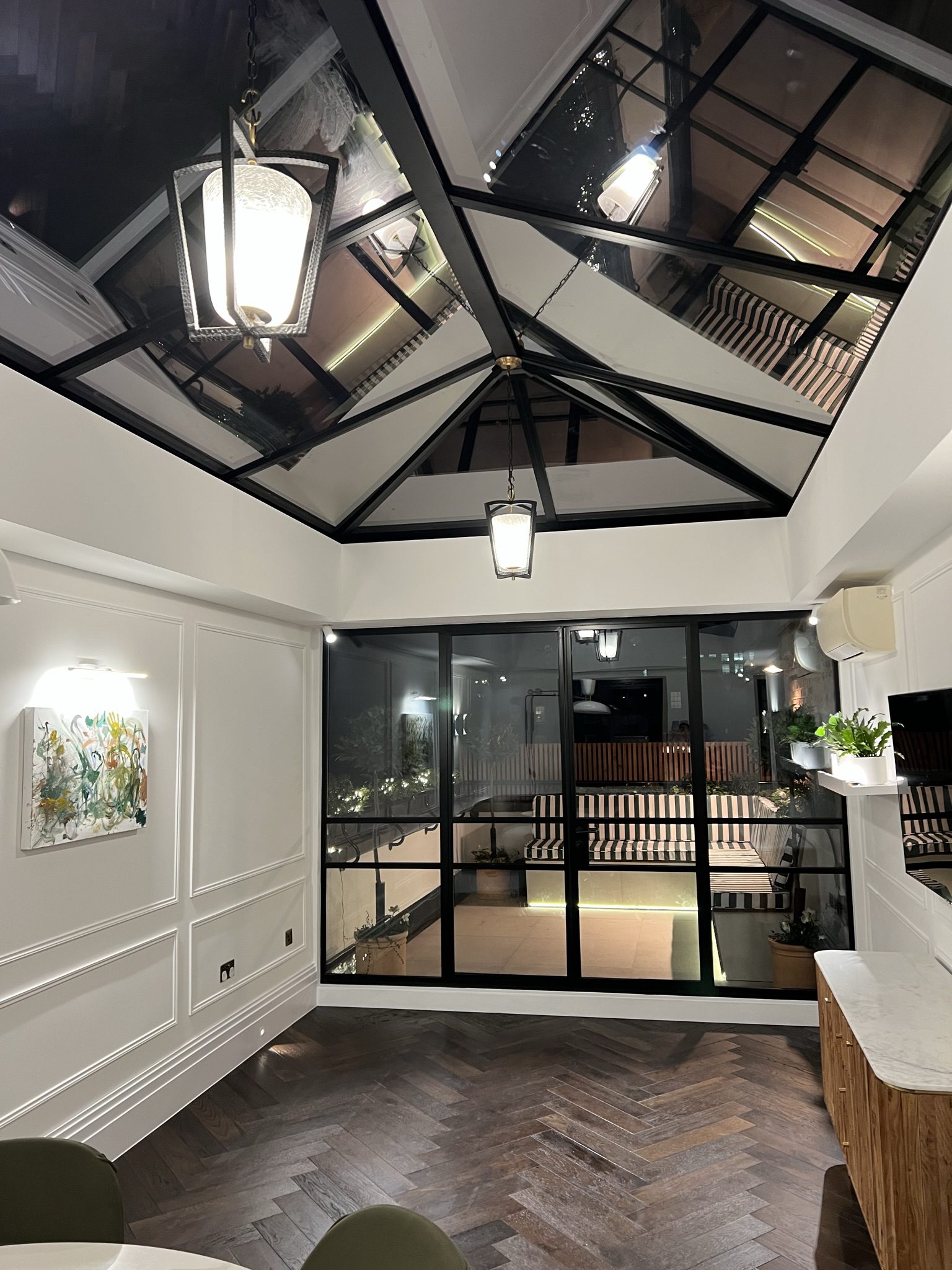 Indoor glass-ceiling atrium with pendant lights