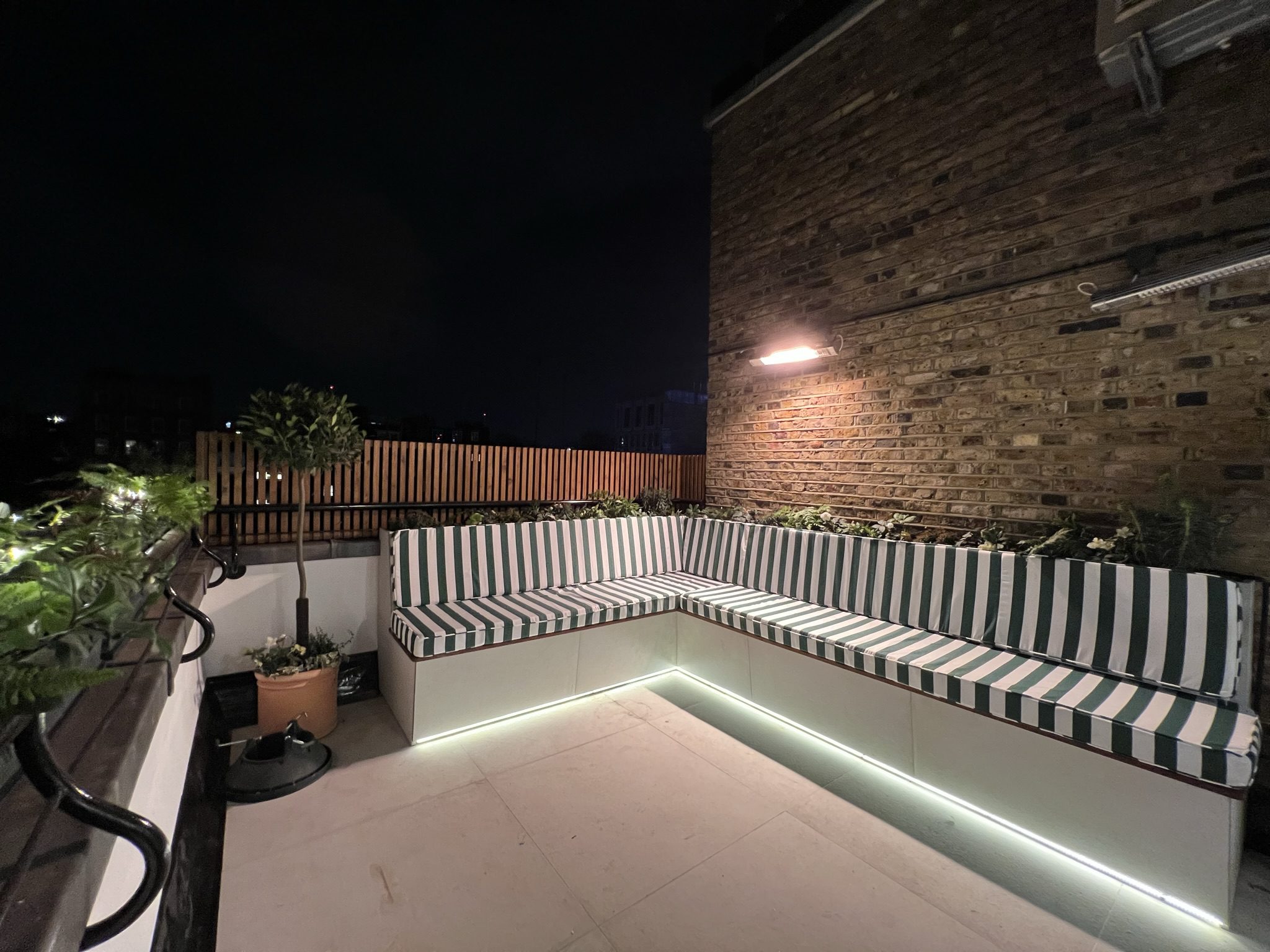 Rooftop lounge with striped L-shaped bench