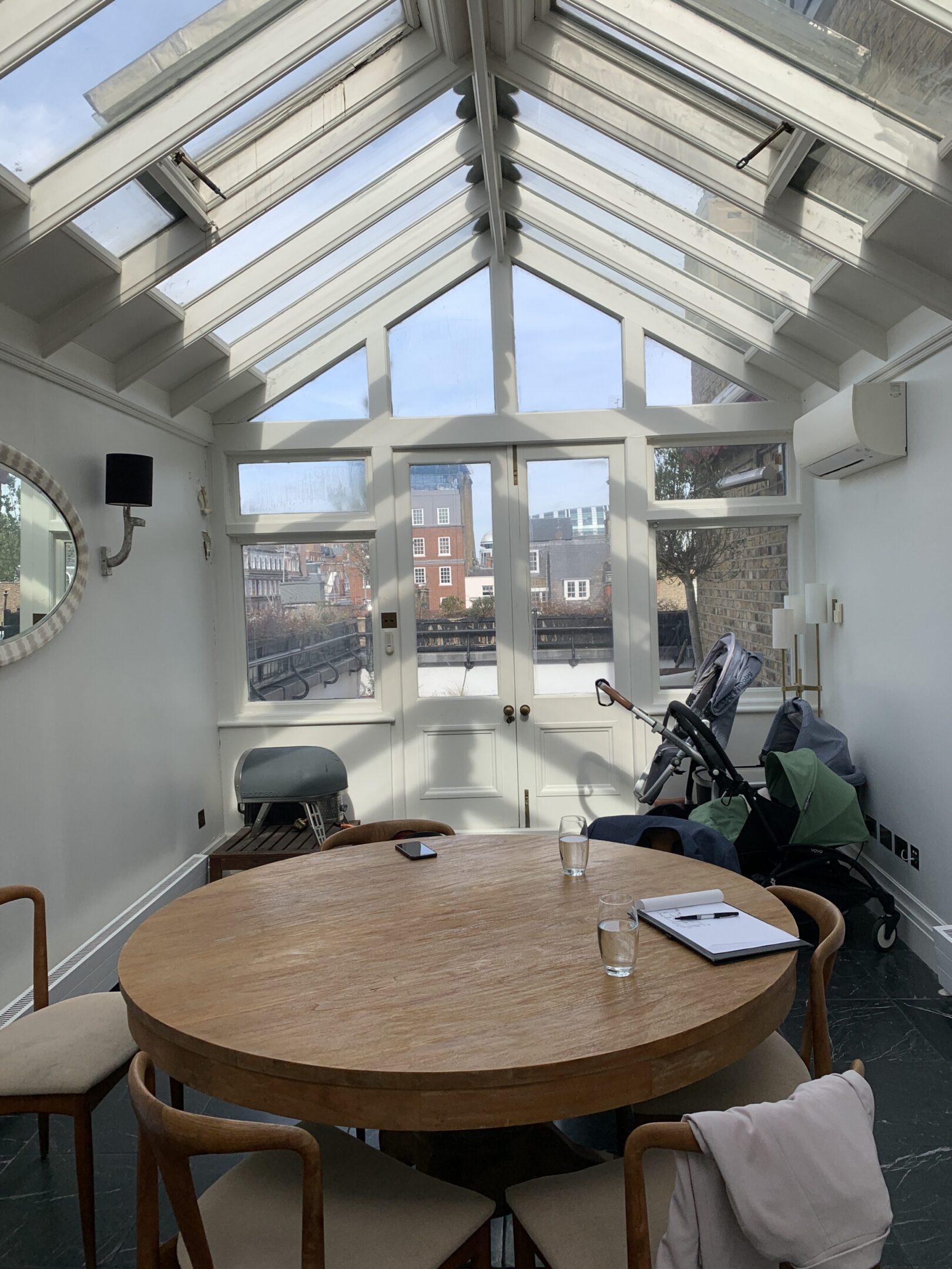 Sunlit conservatory dining room with round table