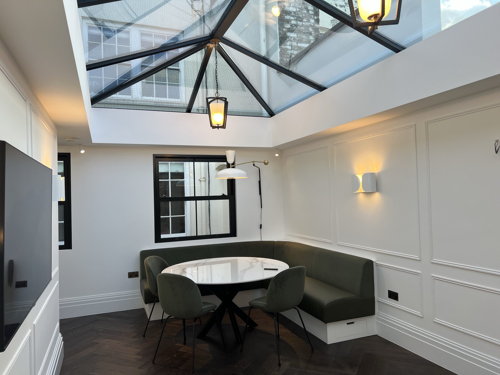 Modern dining nook with glass skylight ceiling