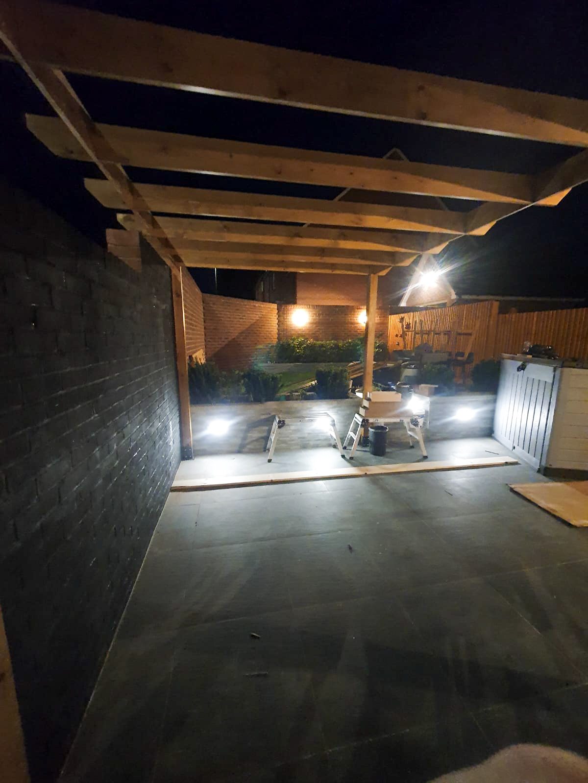 Backyard pergola with outdoor lighting at night