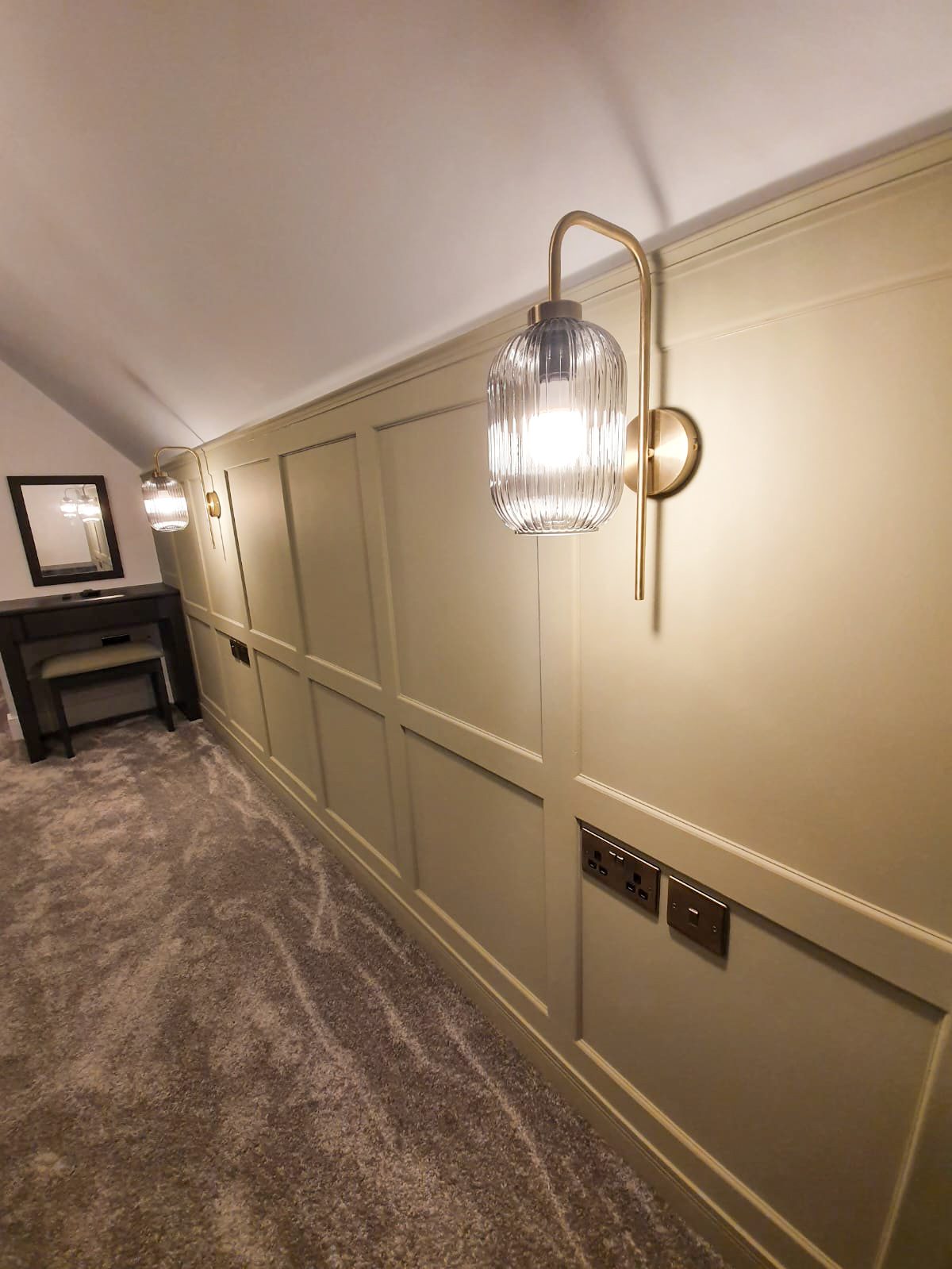 Hallway with ribbed glass wall sconces