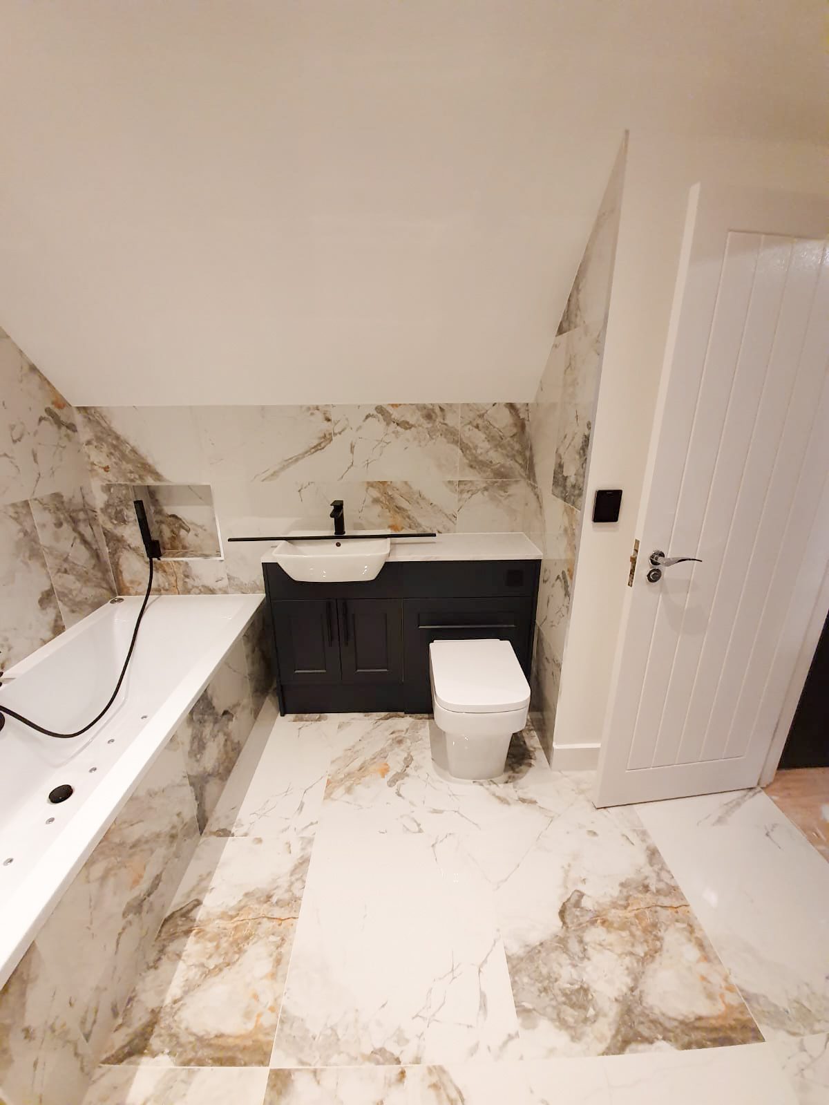 Modern marble bathroom with bathtub and vanity