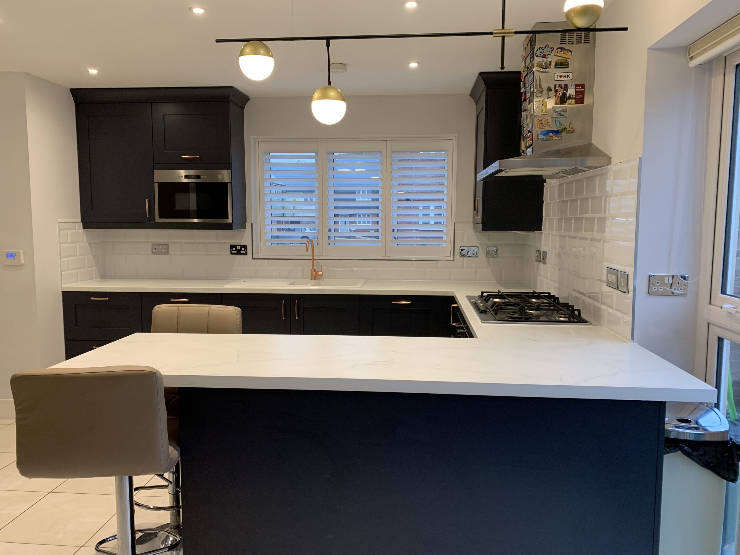 Modern kitchen with black cabinets and island