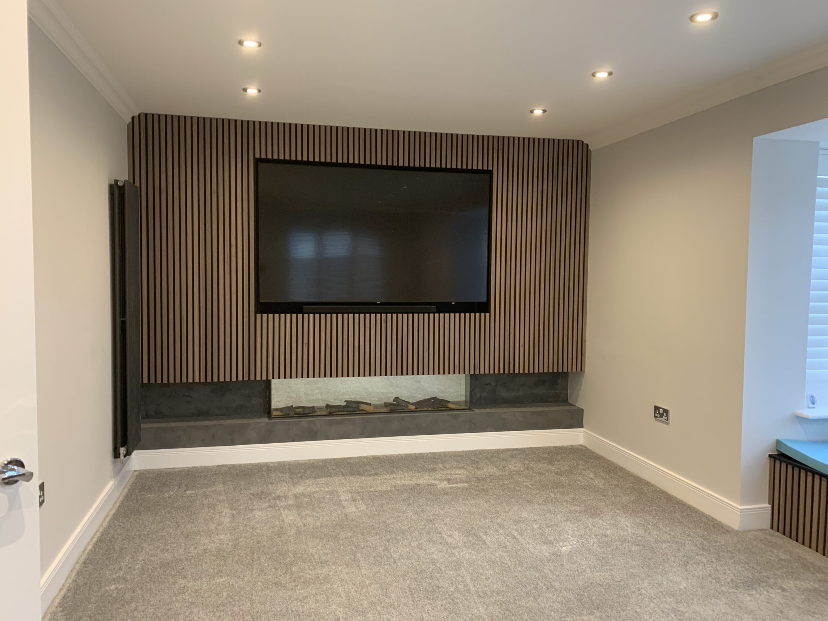 Living room with TV and slatted wood wall