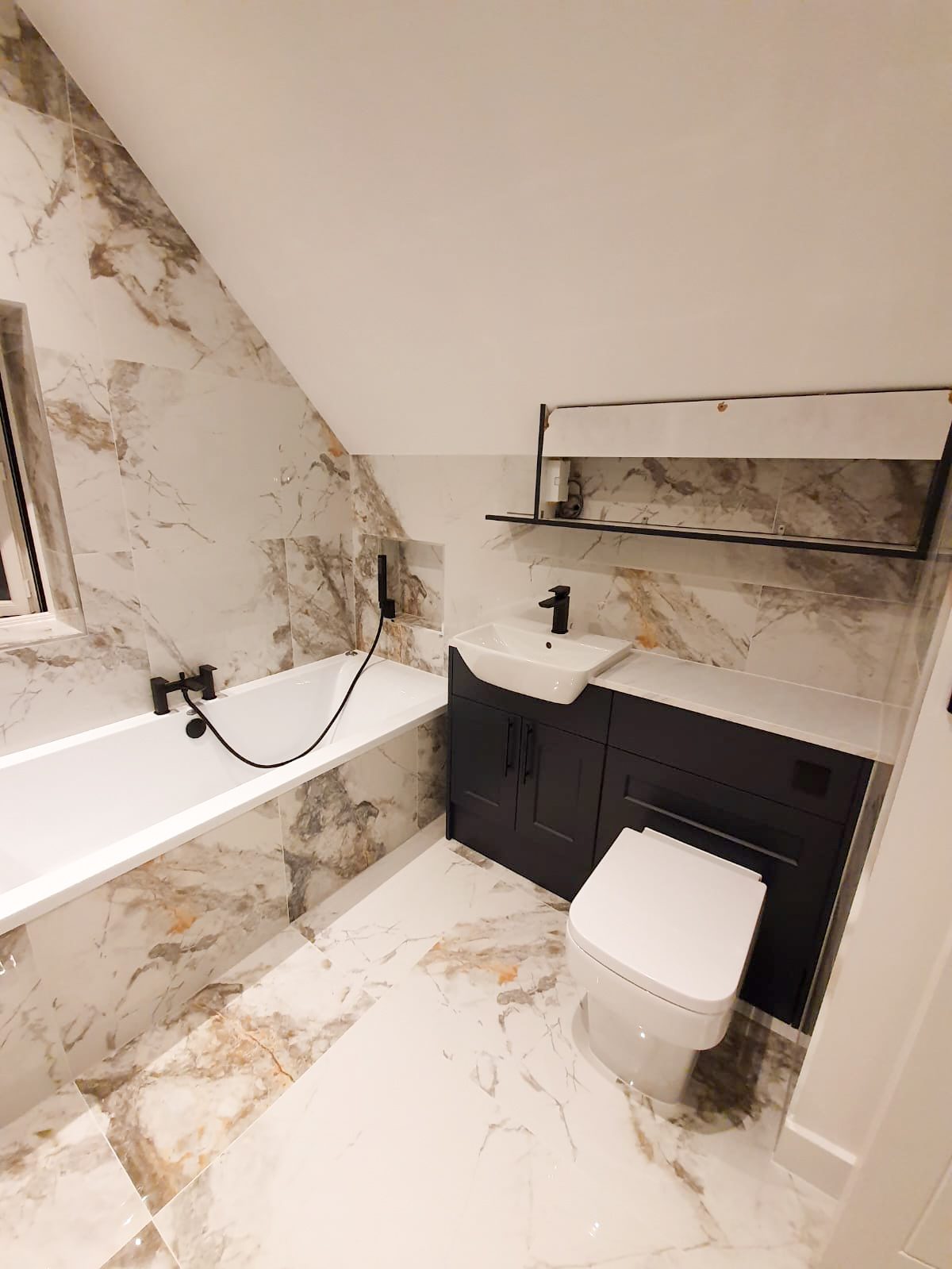 Modern marble bathroom with bathtub and vanity