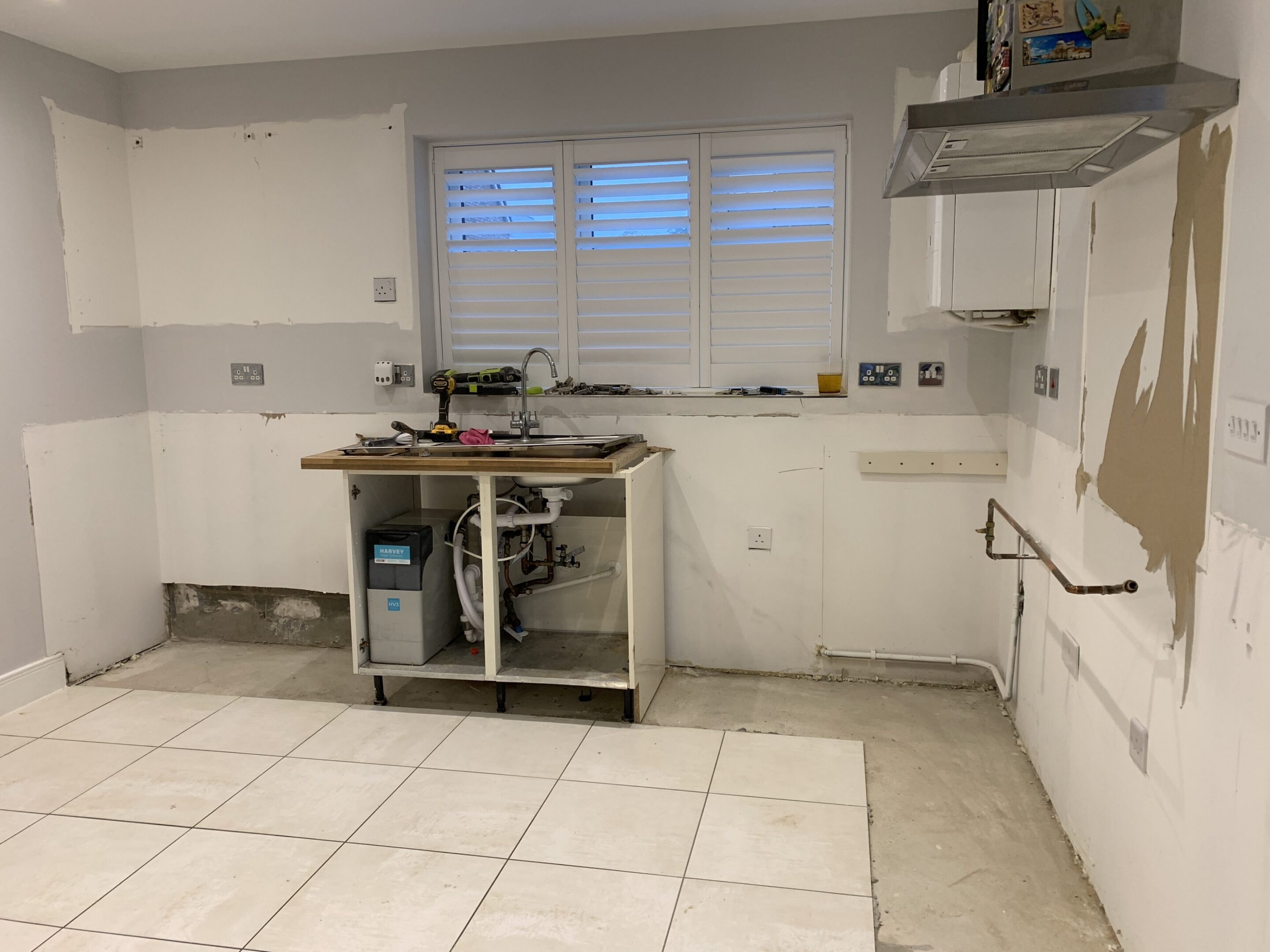 Partially demolished kitchen with exposed plumbing