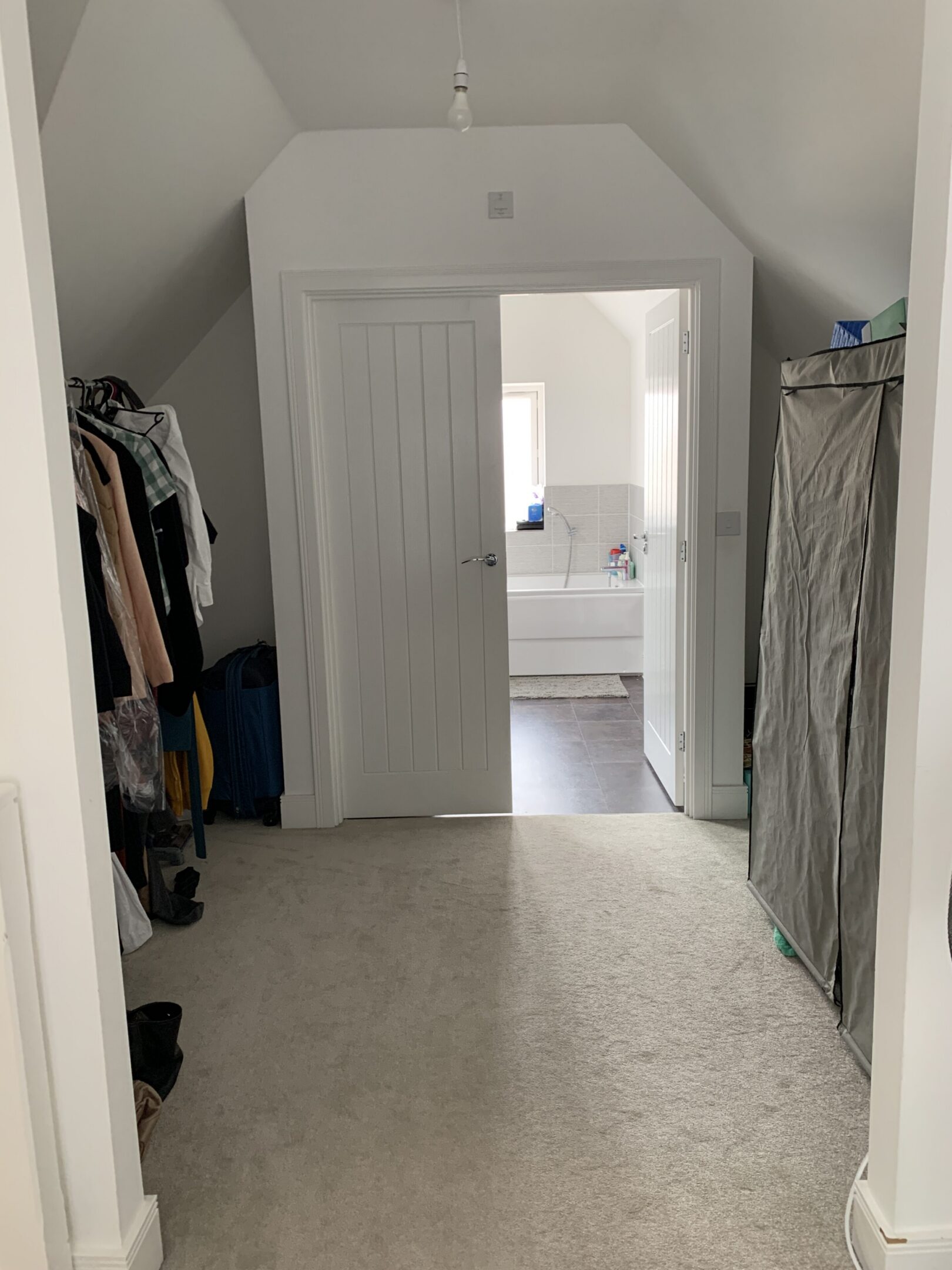 Walk-in dressing area leading to bathroom