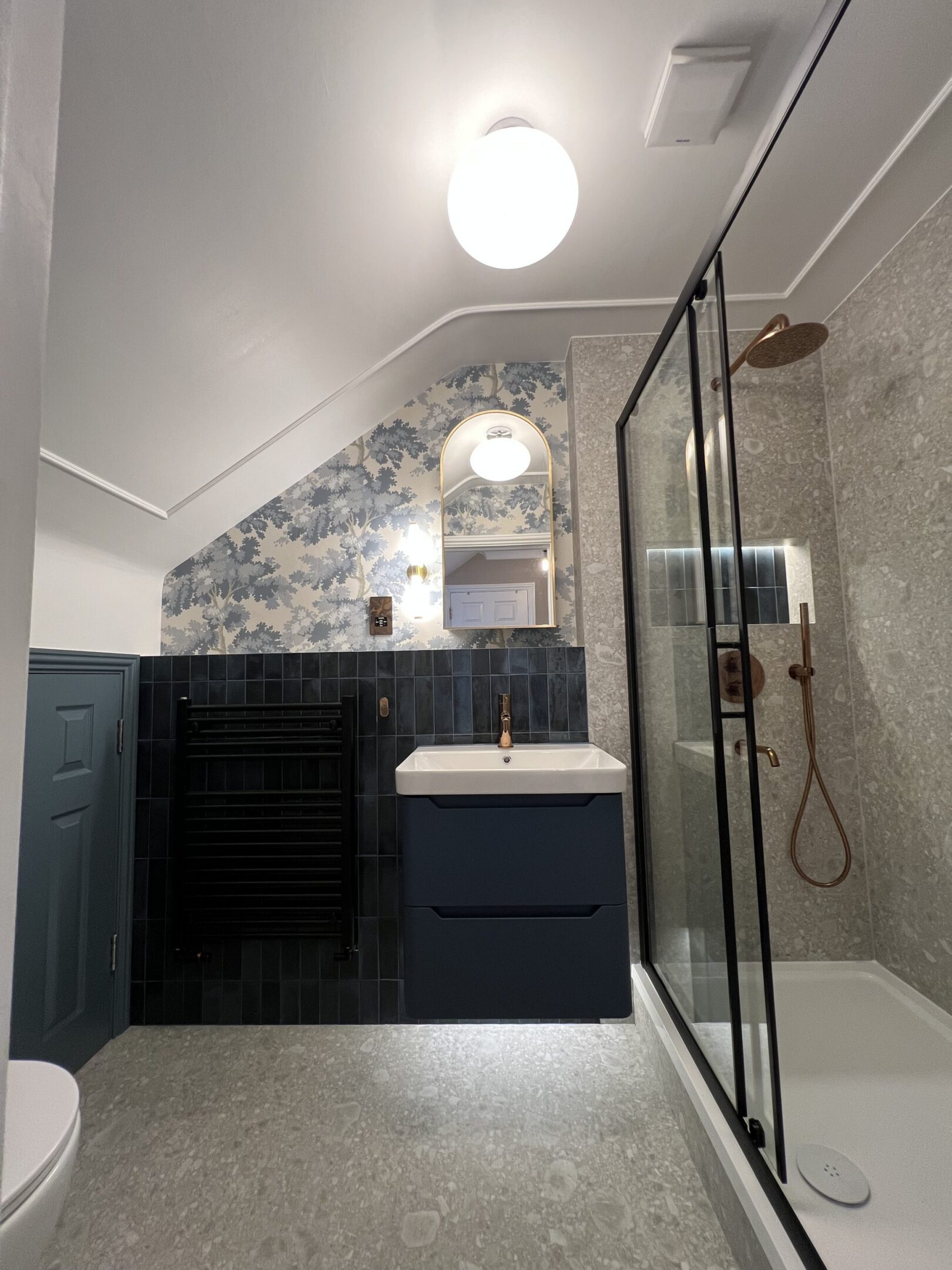 Blue-tiled bathroom with glass shower