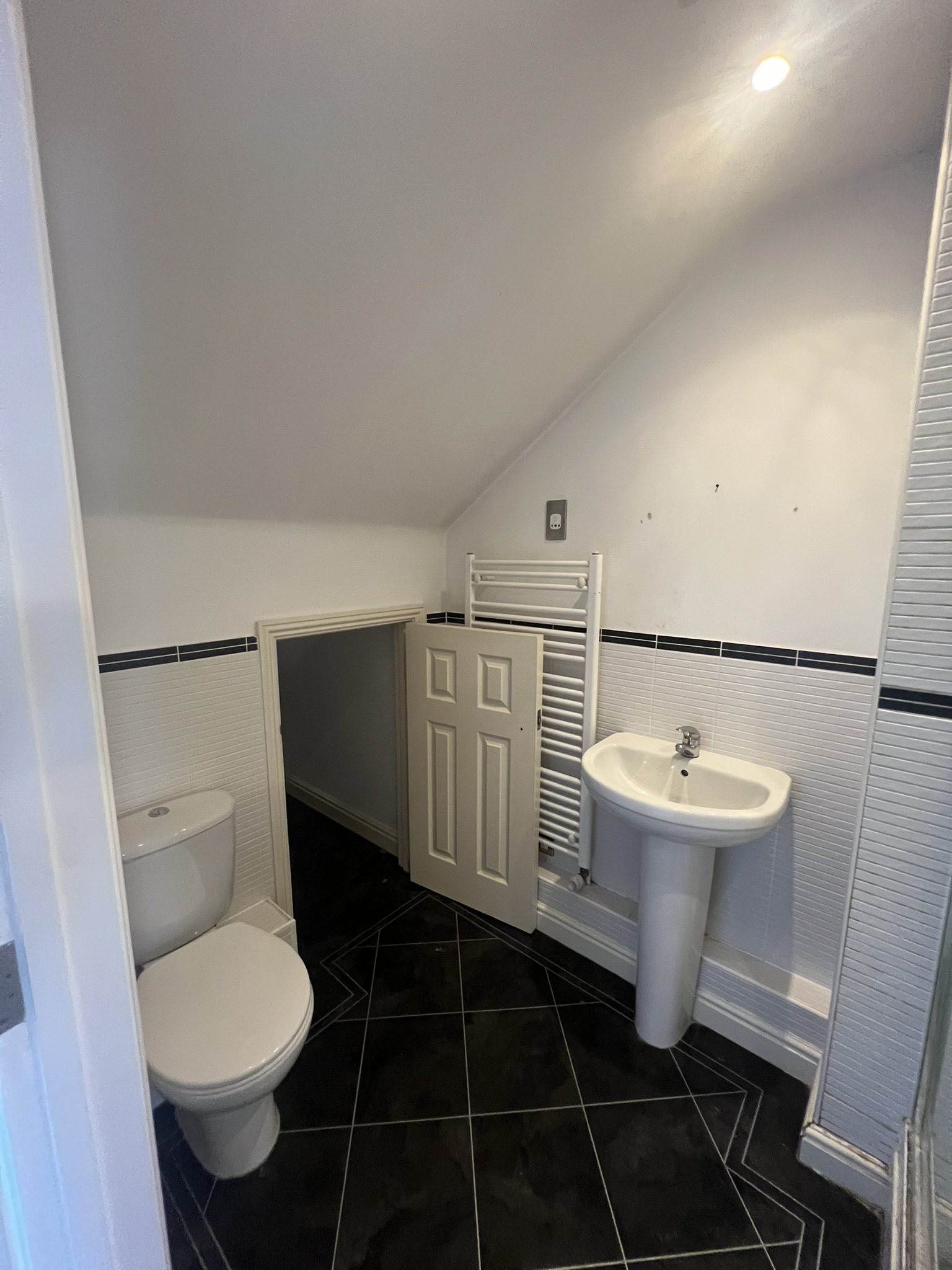 Small attic bathroom with toilet and sink