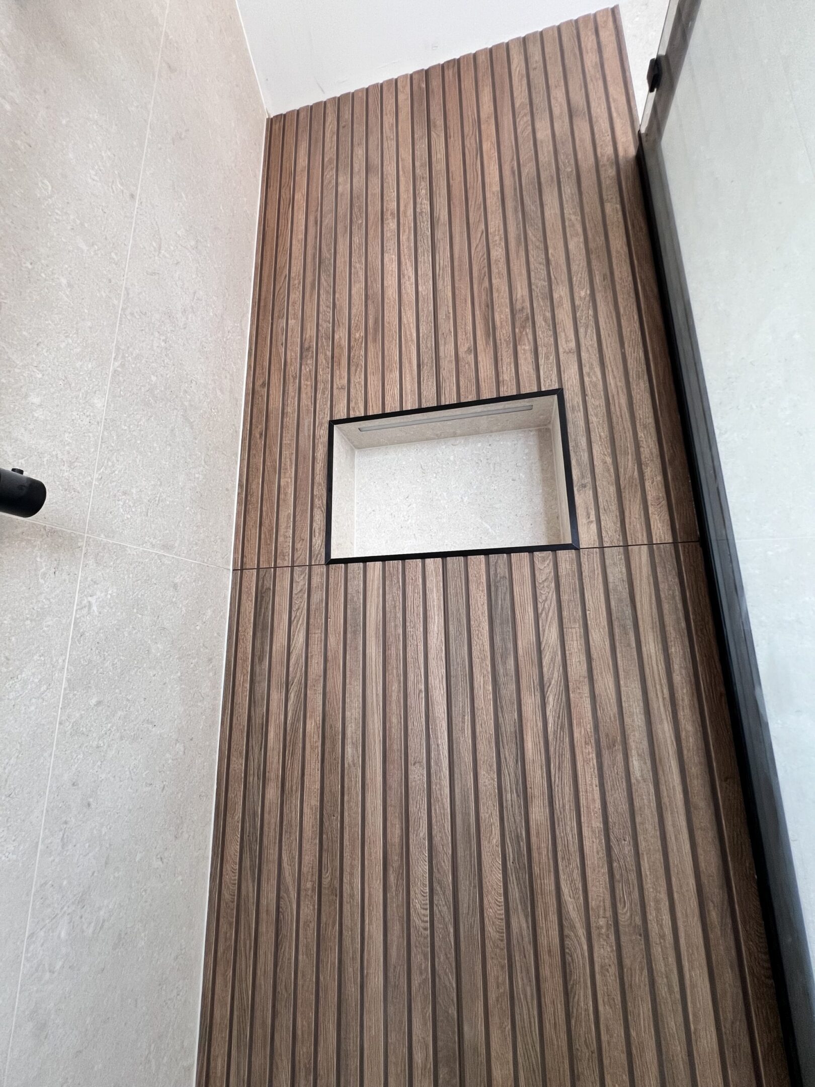 Vertical wooden slat wall with recessed niche