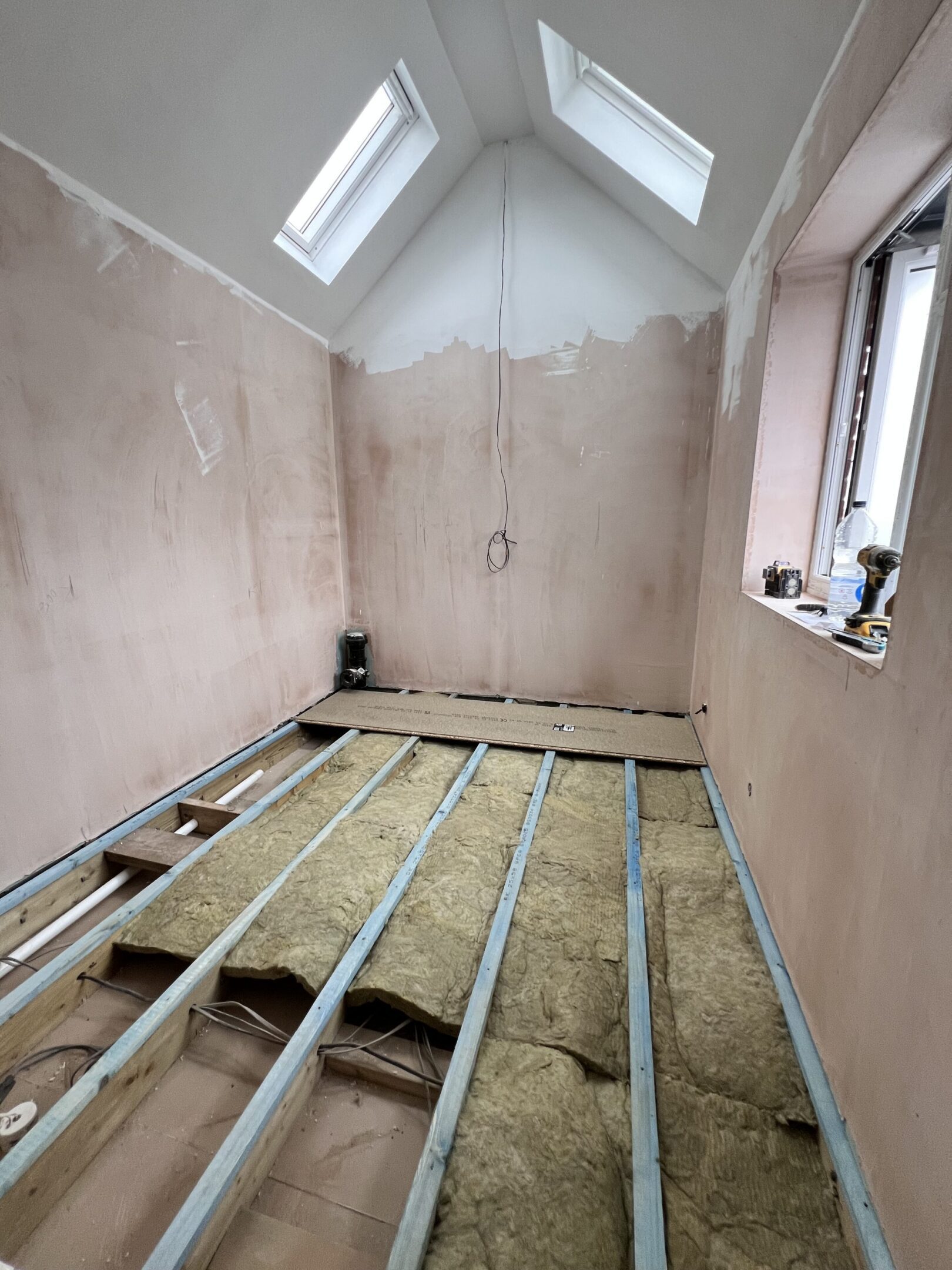 Attic room renovation with exposed floor joists