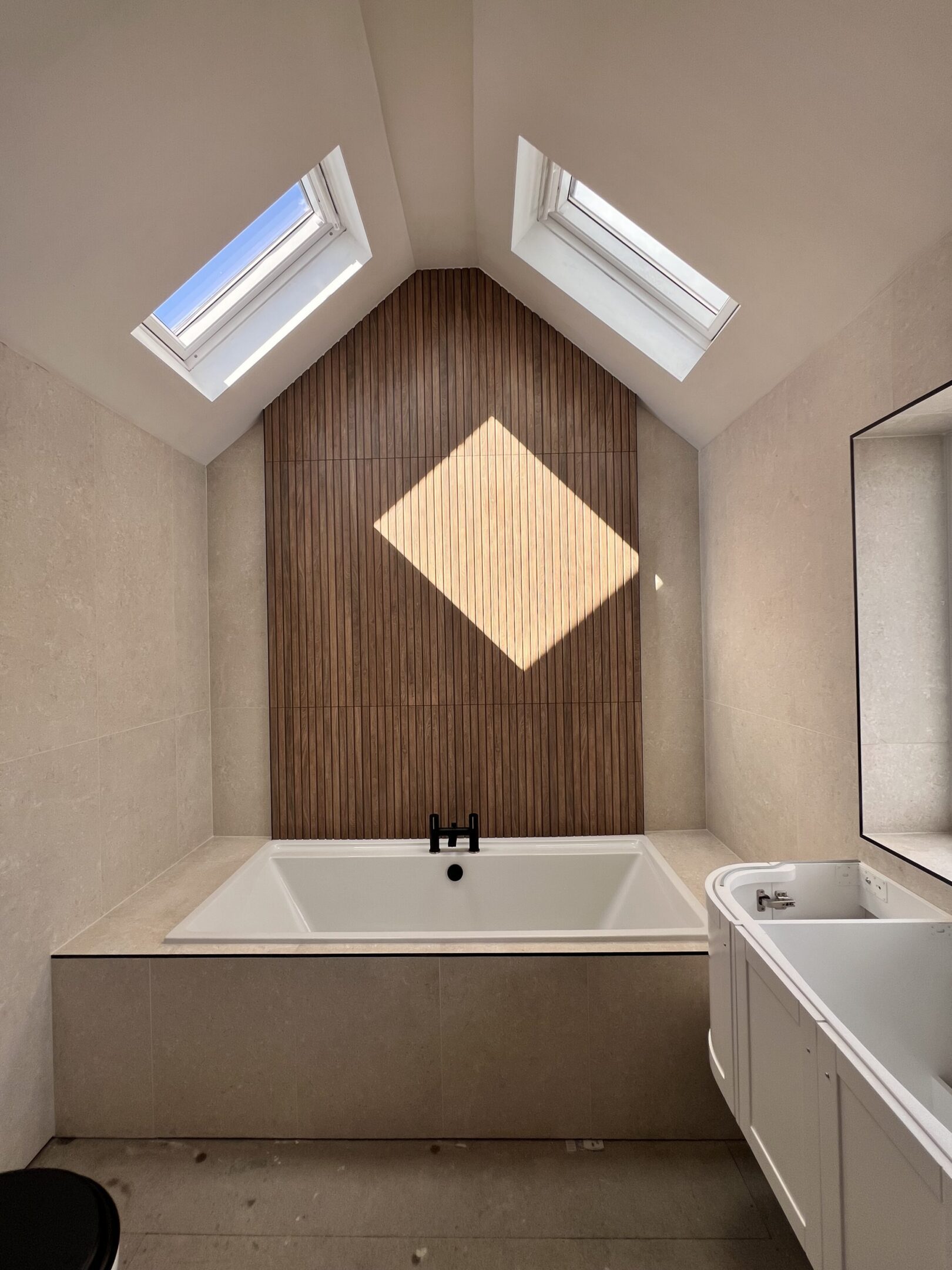 Minimalist bathroom with bathtub and skylights