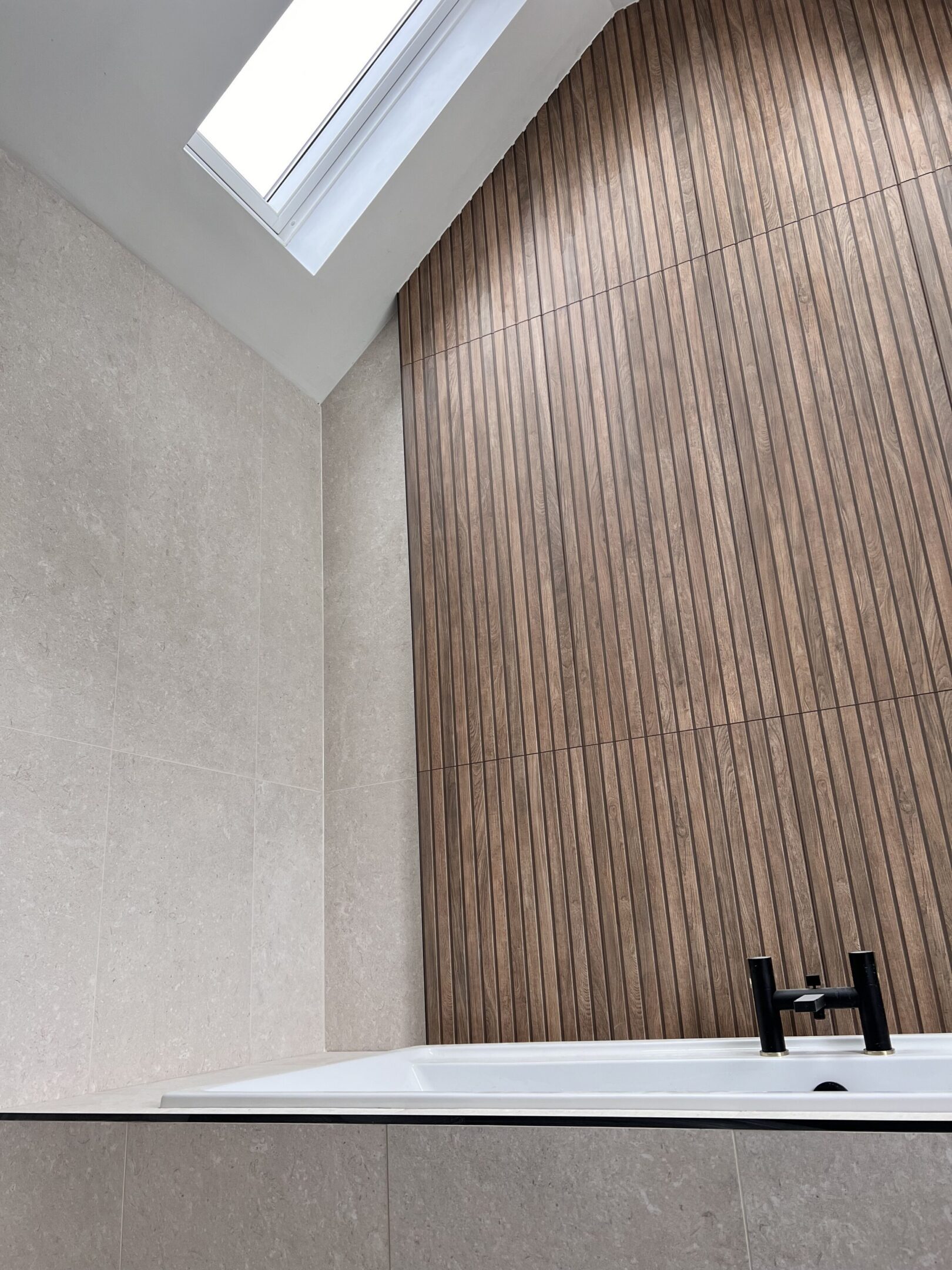 Modern bathtub with wood slat accent wall