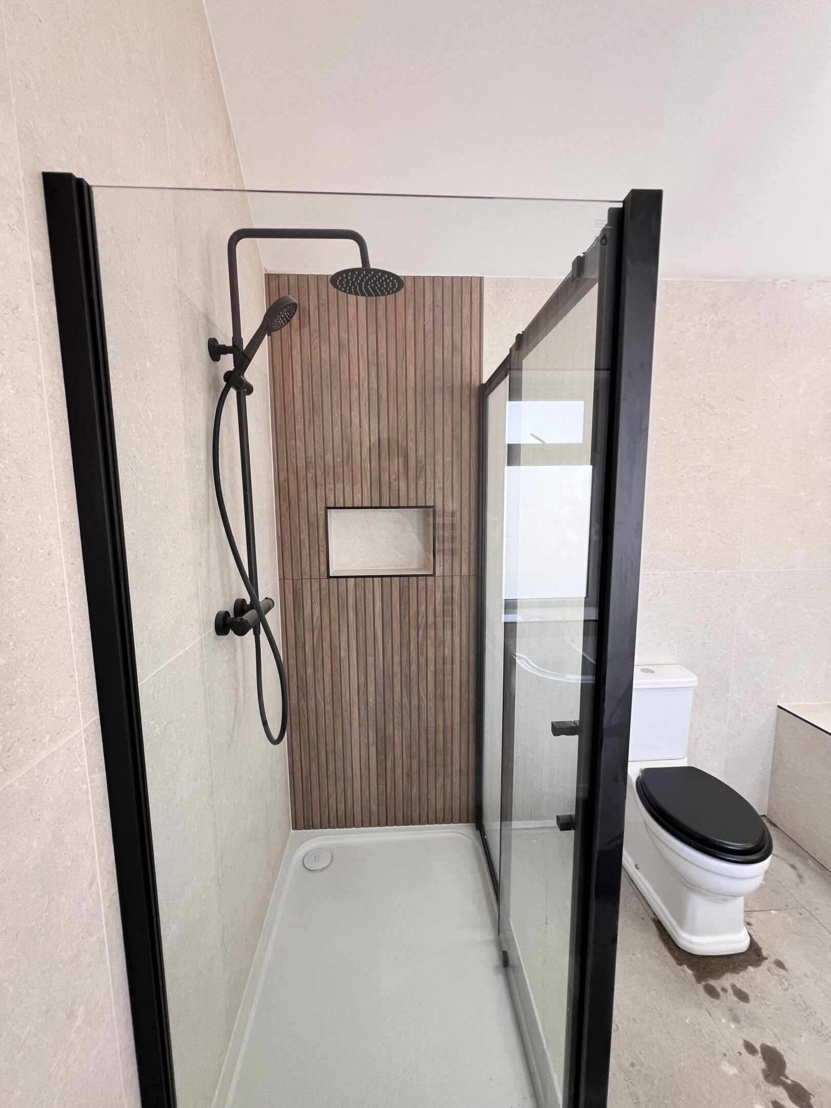 Modern glass shower with black fixtures