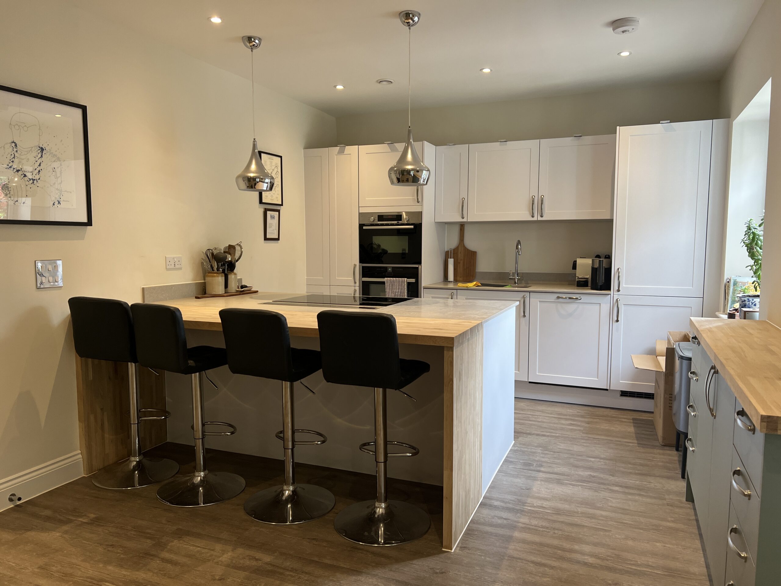 Modern kitchen with island and four bar stools